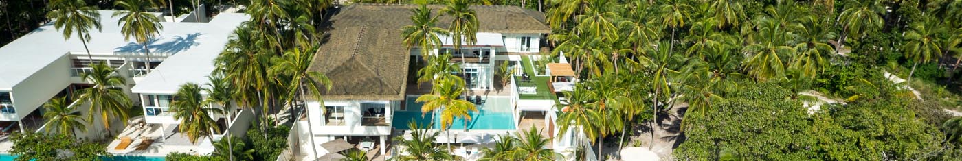 Serene view of the island hotels in Maldives with cone shaped roofing