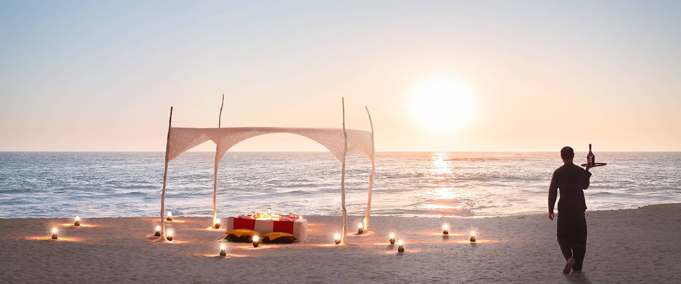 Well arranged dining table in the beach surrounding spotlights