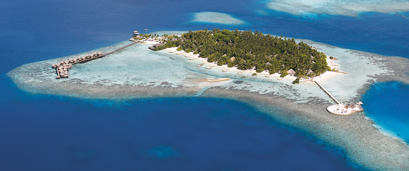 Arial view of Maldives islands with overwater suits around it