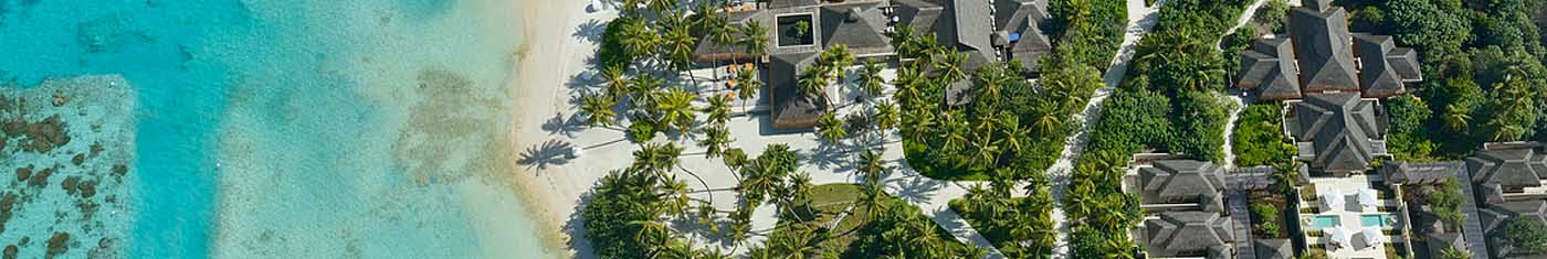 Distance view of the beach cabanas with comfy furniture