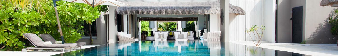 Distance view of the hotel swimming pool with sunbeds