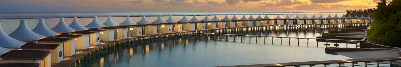 Distance view of over water bungalows In Maldives in sun set