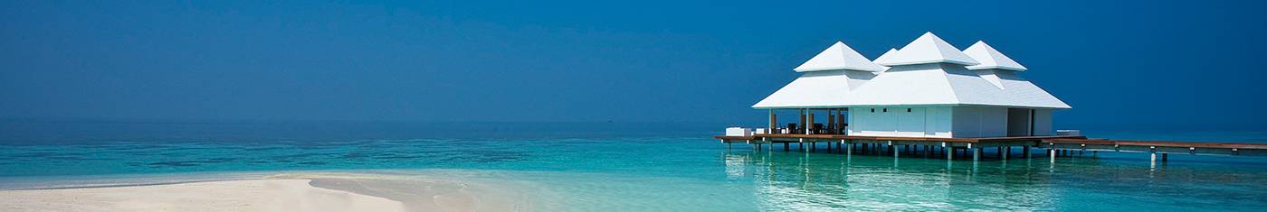 Distance view of an isolated water bungalow on Maldives waters