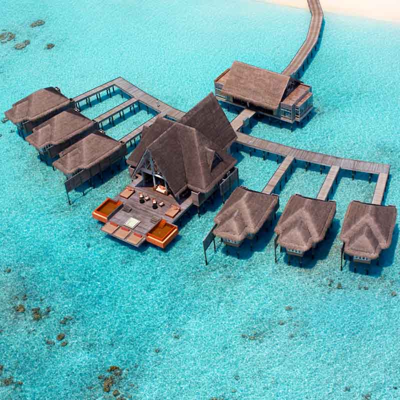 Arial view of the Kihavah hotel with relaxing over water bungalows
